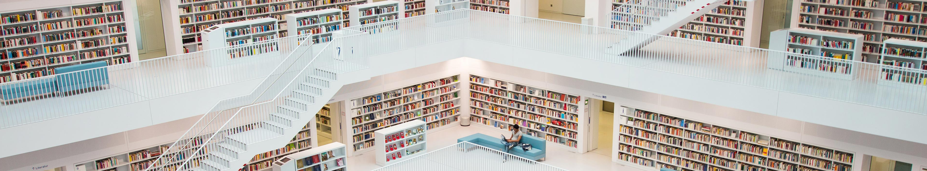 View into a large library. You can see several floors of bookshelves.